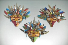 Handcrafted gourd mask with feathered headdress by Donna Vargas